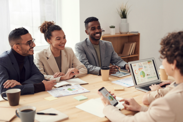 people sitting at conference room table discussing business